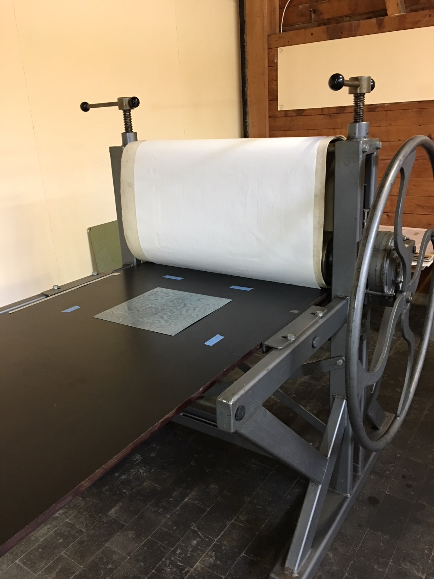Etching press with a plate ready to print